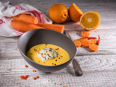 Fruity orange and carrot soup with ginger, chili and zucchini strips