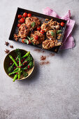 Roasted hummus and peanut-crusted chicken with cherry tomatoes and broccolini