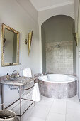 Round bathtub below archway in modern, Oriental bathroom