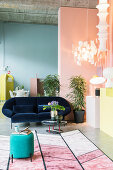 Collection of lamps in seating area of loft apartment with walls in pastel shades and exposed concrete ceiling