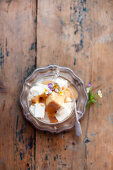 Vanilla ice cream with caramel sauce and viola flowers