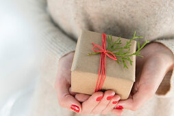 Woman holding small Christmas present