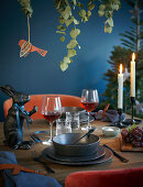 A festively laid table in dark colours