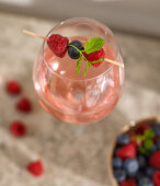 A drink with a berry skewer