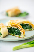 Spinach strudel with spring onions and blue cheese from a tray