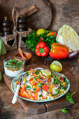 White cabbage salad with vegetables and yogurt dressing