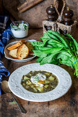 Potato and dock leaf soup with poached eggs