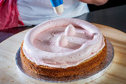 Preparing a wedding cake with an almond base, raspberry buttercream and raspberry filling
