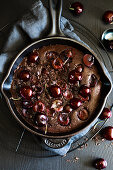 Chocolate clafoutis with cherries in a pan