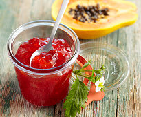 A jar of papaya and strawberry jam