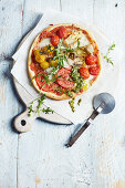 Vegetarian pizza with tomatoes, artichokes, mozzarella and rocket