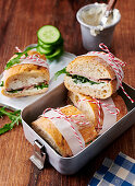 Baguette sandwiches with meatloaf, horseradish, cream cheese and arugula in a lunchbox