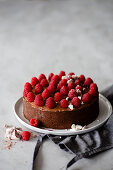 Chocolate mousse cake decorated with raspberries