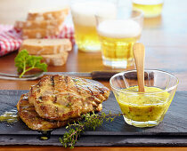 Grilled pork steaks in a herb and mustard marinade, beer and white bread