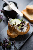 Grilled baguette with cashew cream, cucumber and cress