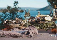 A table laid with seafood and wine by the sea