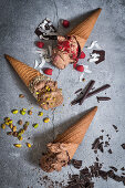 Chocolate ice cream in waffle cones with different toppings