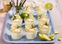Caipirinha cream in jars with mascarpone, limes, coconut and mint