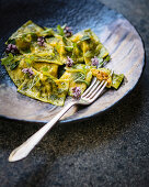 Pumpkin, goat’s cheese and sun-dried tomato ravioli with pickled celery and salsa verde