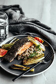 Liquorice and black garlic crusted salmon with buckwheat salad