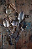 Various silver spoons on a wooden surface