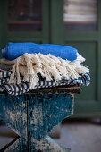 Folded tablecloths on stool