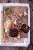 Vintage-style arrangement of garlic cloves, wooden reels and tin