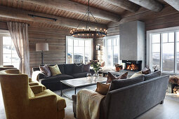 Open fireplace in living room of modern log cabin