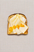 Toasted bread with cheese and orange marmalade