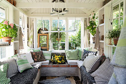 U-shaped masonry bench in summery conservatory