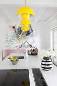 Classic yellow lamp above white kitchen island