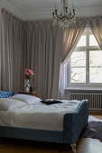 Classic bedroom with wall hangings and curtains