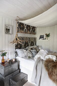 Bedside table made from metal cases next to bed in rustic bedroom