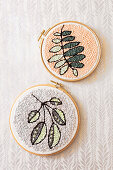 Punch needle leaf motifs in two embroidery frames