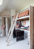 Desk below loft bed in child's bedroom with Wild West theme