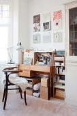 Sheepskin rug on chair at desk below pictures on wall
