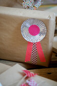Rosette made from praline liners and washi tape on a wrapped gift