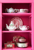 Nostalgic dishes on a pink shelf