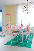 Colourful accessories in white dining room and Christmas tree made from wooden slats