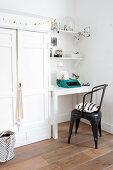 Festively decorated white cupboard next to small desk and chair