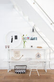 Ornaments on white console table below stairs