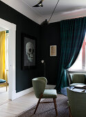 Retro armchair in living room with black wall and skull picture