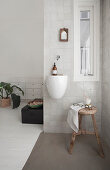 Hand basin and wooden stool in the corner of the room