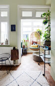 A view of a hanging chair in a conservatory