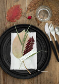 Autumnal plate decoration with pressed leaves