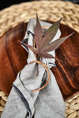 Place setting decorated with autumn leaves