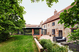 View of extension and existing brick and flint farmhouse