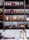 Shelf with women's shoes, including a shelf with sunglasses and jewelry