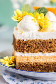 Close-up on layers of carrot cake with cream