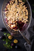 Vegan plum crumble in a baking dish